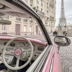 the interior of an old pink car in front of the eiffel tower, paris