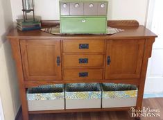 a wooden cabinet with two storage bins under it