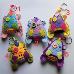 four stuffed animal keychains are shown with numbers on the front and back side