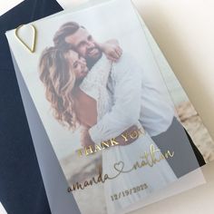 a wedding thank card with an image of a man and woman hugging on the beach