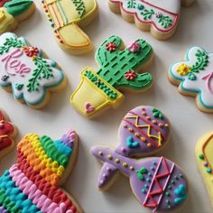 decorated cookies are arranged on a white surface