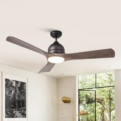 a ceiling fan in a living room next to a window