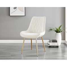 a white chair sitting next to a plant in a room