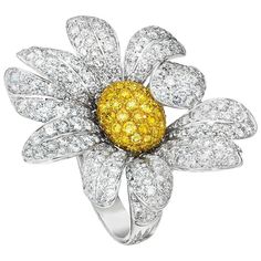 A lovely "Daisy" flower ring having 10 white diamond pave petals, set in 18kt white gold. The petals surround the center which is designed with natural fancy yellow brilliant cut diamonds set in 18kt. yellow gold. Two rows of pave set white diamonds come mid way down the shank. White diamonds total 5.65cts Yellow diamonds total 1.17cts. Stamped Ambrosi 750 Finger size 6.25 Similar ring available with Less Diamonds, and Coordinating Earrings available. Yellow Diamond Rings, Fancy Yellow Diamond, Round Diamond Ring, Diamond Rings Bands, Diamond Flower, Cz Diamond, Jewelry Boxes, Yellow Diamond, Flower Ring