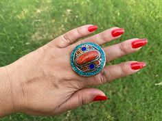 This listing is for 1 piece. At wholesale price Large Tibetan Rings with Turquoise, Coral & Lapis Inlay is absolutely stunning with beautiful adjustable band. You will receive the exact ring shown in the pictures.This high quality durable statement piece ring is handmade in Nepal. Beauty of this ring that is unmatched as they are handmade and are one of a kind. With the nature of them being handmade, each product is unique in its own right and no two products are the exact same. Made with Ti Handmade Multicolor Bohemian Crystal Ring, Adjustable Bohemian Rings With Stones, Bohemian Adjustable Rings With Stones, Bohemian Multicolor Rings For Festival, Bohemian Round Crystal Ring For Jewelry Making, Bohemian Crystal Ring, Adjustable Multicolor Turquoise Bohemian Ring, Adjustable Bohemian Turquoise Ring With Stone Setting, Bohemian Multicolor Rings For Jewelry Making