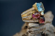 Ring wide: 0.75''/19.5mm Band wide: 0.37''-0.2''/9.8mm-5.2mm This statement ring is made of topaz, tourmaline, opal, diamond, and 18K gold. It's gorgeous and elegant. Perfect for any occasion. Thank you for your interest. Please check out our other items and be sure to add us to your favorites! We look forward to the opportunity of serving you. Formal Multi-stone Ruby Ring With Tourmaline, Formal Multi-stone Tourmaline Ruby Ring, Luxury Multi-stone Tourmaline Ring, Formal Multi-stone Tourmaline Sapphire Ring, Luxury Multi-stone Sapphire Ring With Tourmaline, Diamond Topaz Ring, Opal Diamond Ring, Multi Gemstone Ring, Gold Statement Ring