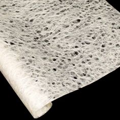 a roll of white paper with black spots on it