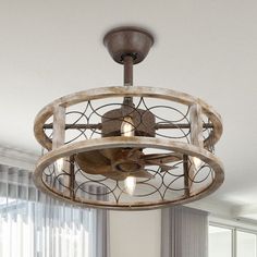 a light fixture in the middle of a room with curtains on the window sill