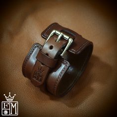 "This brown leather cuff uses vegetable tanned, anerican bridle leather. It is saddlestitched by hand and edges are burnished and waxed smooth! It has a 3/4\" strap woven through the center. A beautiful roller buckle closes it up. I'll need your wrist size for this cuff! Please use the instructions in the last pic above! - 2\" wide - Luxury construction - Beautiful bridle leather Thanks for checking out my work! I use a fine hand in my work bridging the gap between craft and art and truly love m Handmade Vintage Leather Wristband, Classic Leather Bracelet With Waxed Finish, Vintage Brown Leather Cuff Bracelet, Vintage Leather Cuff Bracelet In Distressed Brown, Rugged Leather Bracelets, Classic Adjustable Leather Wristband, Adjustable Classic Leather Wristband, Vintage Distressed Brown Leather Cuff Bracelet, Classic Handmade Leather Cuff Bracelet