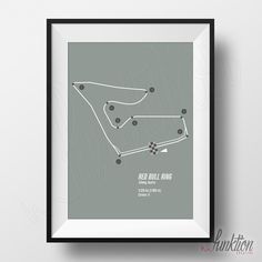 a framed poster with the red bull driving circuit in grey and black, on a white wall