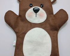 a brown teddy bear with white paws on it's chest