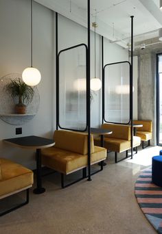 an empty waiting area with yellow chairs and tables