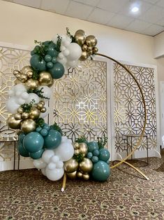 a balloon arch with gold, white and blue balloons