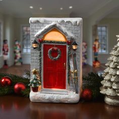 a christmas scene with a red door and decorations