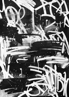 black and white photograph of graffiti on a wall