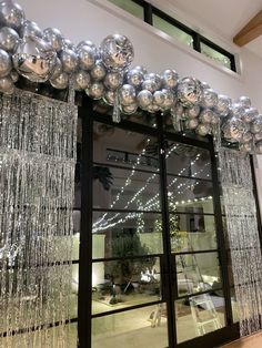 an entrance to a building decorated with silver balloons