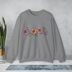 Experience ultimate comfort in style with our Boho Wildflower Crewneck Sweatshirt crafted with Unisex Heavy Blend™ fabric. This sweatshirt's unique design showcases beautiful wildflowers, bringing a touch of nature-inspired charm to your wardrobe. Stay cozy and stylish all day long with this versatile sweatshirt that blends comfort and elegance effortlessly.. #1 Unisex Crewneck Sweatshirt Ideal Unisex Crewneck Sweatshirt Experience pure comfort in any situation with our unisex heavy blend crewneck sweatshirt. Crafted from a blend of 50% cotton and 50% polyester (8.0 oz/yd² or 271.25 g/m²), this sweatshirt is not only cozy but also the perfect choice for colder months. Key Features: Medium-heavy fabric blend for comfort Classic fit and crew neckline for a clean-cut style Double-needle stitc Cotton Floral Print Sweatshirt For Fall, Casual Relaxed Fit Sweatshirt With Floral Embroidery, Casual Sweatshirt With Floral Embroidery And Relaxed Fit, Casual Floral Embroidery Sweatshirt With Relaxed Fit, Flower Shaped Relaxed Fit Sweatshirt For Fall, Relaxed Fit Flower Sweatshirt For Fall, Boho Sweatshirt, Boho Wildflower, Clean Cut