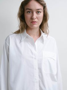 There's a lot of white button-ups out there, but this one has the most fun with its unique pocket, back yolk, side slits, and overall silhouette. It has that 'I'm simple but beautifully complicated' feeling, reminding you that your depth is something to be treasured. Everyday Shirt With Buttoned Pockets And Shirttail Hem, White Relaxed Fit Top With Buttoned Pockets, White Tops With Buttoned Pockets And Relaxed Fit, White Shirt With Pockets For Daywear, Classic White Shirt With Buttoned Pockets, White Shirt With Shirttail Hem For Everyday, White Blouse With Buttoned Pockets For Work, White Button-up Blouse With Buttoned Pockets, White Shirt With Buttoned Pockets For Work