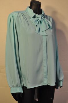 "Womens vintage light blue polyester button down blouse The blouse is in good, clean condition. The label reads: David Matthew Size  16 Approximate Measurements Laying Flat: Armpit to armpit - 23\" Shoulder to shoulder - 17\" Sleeves from top shoulder- 24\" Top collar to bottom hem- 27\" REFUNDS & EXCHANGES With vintage being one of a kind, all sales are final.  Please review the description and pictures before purchasing.  Feel free to send a message with any questions you may have! Item #353" Chic Light Blue Formal Blouse, Chic Light Blue Blouse For Formal Occasions, Vintage Blue Button-up Blouse, Retro Spring Blouse For Formal Occasions, Retro Formal Blouse For Spring, Elegant Light Blue Blouse For Daywear, Vintage Button-up Office Blouse, Vintage Button-up Blouse For Office, Light Blue Vintage Button-up Tops