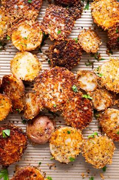 some fried food is laying on a sheet of paper with parmesan sprinkles