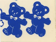 two blue teddy bears with bows on their heads, one holding the other's hand