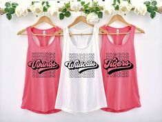 two women's tank tops hanging on a rack