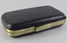 an empty black and gold case on a white surface