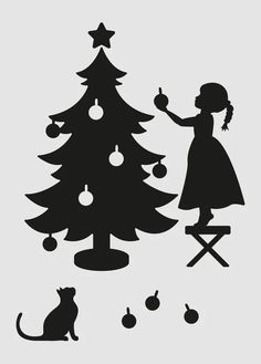 a black and white silhouette of a girl decorating a christmas tree with her cat