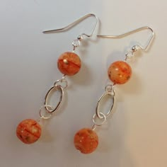 Handcrafted Beaded Pierced Dangle Earrings. Orange Swirl Ceramic Beads. Silver Metal Oval Hoop Rings & Earwires. Approx. 2 1/2" Long. New With Tag. Homemade Bead Earrings, How To Make Earrings With Beads, Unique Jewelry Inspiration, Boho Earrings Diy, Ceramic Bead Jewelry, Handmade Bead Jewellery, Pearl Earrings Handmade, Beautiful Beaded Jewelry