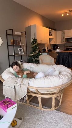 a woman laying on top of a couch in a living room