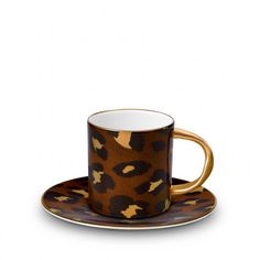 a coffee cup and saucer with an animal print pattern