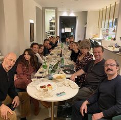 a group of people sitting around a dinner table