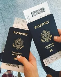 two people are holding up their passports in front of each other, both with the same name on them