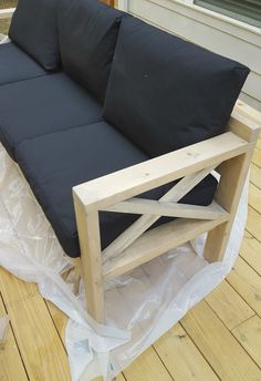 a black couch sitting on top of a wooden floor