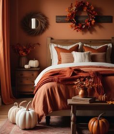 a bedroom decorated with pumpkins and other decorations in shades of orange, white and brown