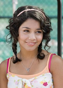 a young woman wearing a pink and white top with a bow in her hair smiling at the camera