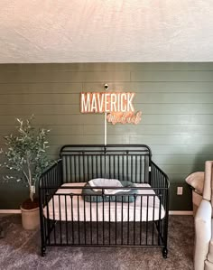 a baby crib with a sign that says maverick and clark