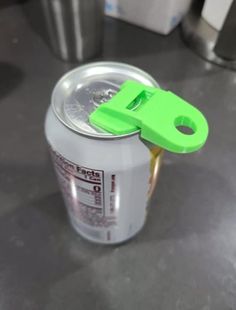 an empty can with a green lid on a table