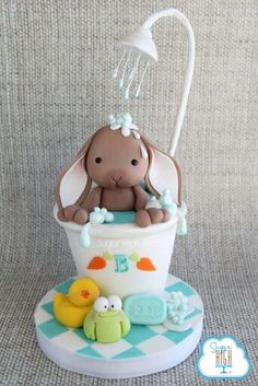 a baby shower cake with an elephant in the tub