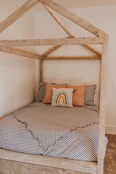 a bed with a wooden frame and pillows on it