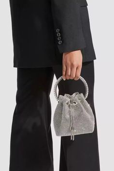 Love the Harlow Silver Crystal Embellished Bucket Bag for all occasions! This bag is made of PU material, and the surface is inlaid with hot diamonds. The chain allows you to straddle your body diagonally. The handle on the top makes it easy to carry it anywhere. This is a great accessory choice whether worn with dress Embellished Bags, Embellished Heels, Rhinestone Clutch, Drawstring Bucket Bag, Rhinestone Decor, Bon Bon, Elegant Accessories, Mesh Bag, Solid Tops