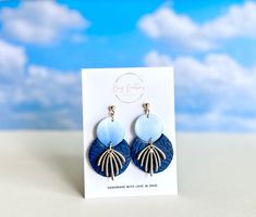 Featuring a stunning gradient of blue hues that create an elegant ombre effect, these handcrafted earrings are modern and classic at the same time. The textured navy combined with the gold accents add a cool touch of color to any outfit. Crafted from lightweight polymer clay and set on a hypoallergenic, nickel-free 4 mm gold ball post, these earrings make thoughtful gift for yourself or someone else. As with all handmade items, small imperfections, variations in color and size are possible. This Modern Blue Long Drop Jewelry, Modern Blue Long Drop Earrings, Modern Blue Teardrop Earrings, Blue And Gold Jewelry, Whimsical Blue Polymer Clay Earrings, Blue Polymer Clay Dangle Jewelry, Light Blue Clay Earrings, Dark Blue Clay Earrings, Artsy Blue Polymer Clay Earrings