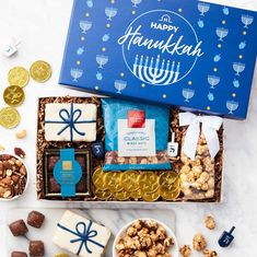 the happy hanukkah gift box is filled with chocolates, nuts and crackers