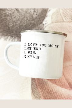 a white coffee mug with the words i love you more than the end, i win