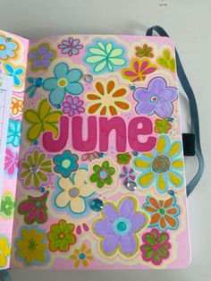 a book with flowers and the word june written in pink, blue, green, yellow and purple