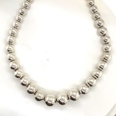 San Diego Jewelry Buyers Tiffany & Co. Sterling Silver Graduating Bead Ball Necklace 16" Brand Tiffany & Co. Model Bead Ball Necklace Designer N/A Length 16" Width 6mm-11mm Clasp Lobster Material Sterling SIlver Weight 28.8g Stones No Stones MSRP ? Delivery Contents Necklace only INVENTORY #: 111985338289387100 Store Info Website: sandiegojewelrybuyers.com Instagram: sandiegojewelrybuyers We only sell high quality previously owned jewelry All of the measurements are approximations If an item includes paperwork or the original box the listing will state this.  All brand items are genuine and stamped If any stones are enhanced the item specifics and description will state this. Shipping Costs Shipping costs will be stated. International Shipping costs change depending on location and insuran Bead Ball, Ball Necklace, All Brands, Necklace Sterling Silver, Fine Jewellery Necklace, Tiffany & Co., Original Box, San Diego, Jewelry Watches