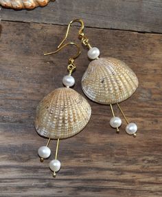 "Stylish earrings with beautiful seashells and white freshwater pearls. 18K gold plated nickel-, lead- and cadmium-free stainless steel hooks. Measure about 54mm (2,1\") from the lower part of the hook. These earrings will come in a pretty organza gift bag ready for gifting! If you have any questions just convo me and I will get back to you as soon as possible. Thanks for looking // Mari" Cowrie Jewelry, Mermaid Jewelry Diy, Seashell Jewelry Diy, Shark Teeth Jewelry, Beautiful Seashells, Chic Natural, Shell Crafts Diy, Seashell Earrings, Mermaid Jewelry