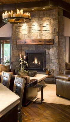 a living room filled with furniture and a fire place in the middle of a room