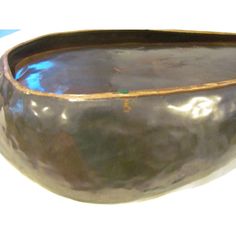 a large metal bowl sitting on top of a table