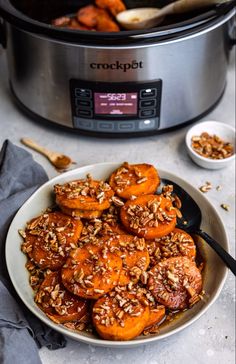 a white plate topped with sliced bananas and granola next to an instant pressure cooker